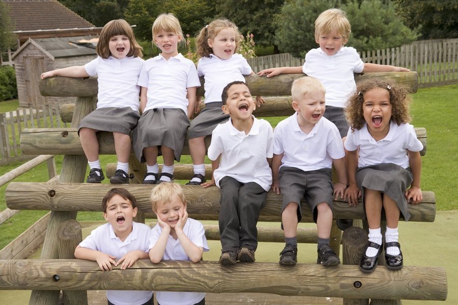 Young children sitting on benches and yelling